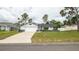 Charming single Gathering home featuring a well-maintained lawn and a concrete driveway at 11494 Villa Rd, Spring Hill, FL 34609