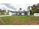 Charming home featuring a well-manicured lawn and decorative landscaping at 11494 Villa Rd, Spring Hill, FL 34609