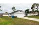 Exterior view of the attached two-car garage and home exterior at 11494 Villa Rd, Spring Hill, FL 34609
