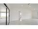 Bright living room features white walls, marble floors, and sliding glass doors that lead to an enclosed lanai at 11494 Villa Rd, Spring Hill, FL 34609