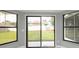 Sun Room features windows with backyard views and sliding glass doors at 11494 Villa Rd, Spring Hill, FL 34609