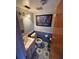 Small bathroom with blue walls, white fixtures, and patterned tile flooring at 11726 Oceanside Dr, Port Richey, FL 34668