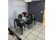 Dining area with a glass-top table and black chairs at 11726 Oceanside Dr, Port Richey, FL 34668