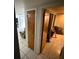 Hallway with tile flooring leading to the living area and bedroom at 11726 Oceanside Dr, Port Richey, FL 34668