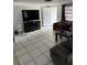 Living room featuring tile flooring and a sitting area at 11726 Oceanside Dr, Port Richey, FL 34668