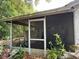 Screened patio featuring tiled flooring and various outdoor items at 11726 Oceanside Dr, Port Richey, FL 34668