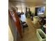 View of a room with tiled flooring, chairs, and access to other rooms at 11726 Oceanside Dr, Port Richey, FL 34668