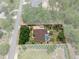 Overhead view of a home featuring a large yard, screened pool, and a long driveway at 12403 Moneta Rd, Weeki Wachee, FL 34614