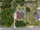 An aerial view shows the home, screened in pool, landscaped yard, and a boat on the hardscaped drive at 12403 Moneta Rd, Weeki Wachee, FL 34614