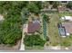 Aerial view of home featuring mature trees, screened pool, landscaped yard, and fire pit at 12403 Moneta Rd, Weeki Wachee, FL 34614