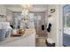 Bright bathroom featuring a glass-enclosed shower, neutral tile, and a light countertop with decorative accents at 12403 Moneta Rd, Weeki Wachee, FL 34614