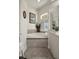 Bathroom featuring a soaking tub with tile surround and a window with shutters at 12403 Moneta Rd, Weeki Wachee, FL 34614