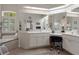 Bright bathroom with a large vanity, double sinks, and a garden tub underneath a window at 12403 Moneta Rd, Weeki Wachee, FL 34614