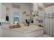 Well-lit bathroom showcasing a white vanity, framed mirror, storage cabinet, and view of the pool area at 12403 Moneta Rd, Weeki Wachee, FL 34614