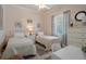 Comfortable bedroom with two twin beds, a neutral color scheme, and a bright window providing natural light at 12403 Moneta Rd, Weeki Wachee, FL 34614