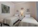 Cozy bedroom with twin beds, nautical-themed decor, and a soft color palette for a relaxing atmosphere at 12403 Moneta Rd, Weeki Wachee, FL 34614