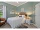 Cozy bedroom featuring seafoam green walls, carpeted floors, and bright natural light at 12403 Moneta Rd, Weeki Wachee, FL 34614