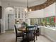 Bright breakfast nook features tile floors, modern lighting and views of the outdoor seating area at 12403 Moneta Rd, Weeki Wachee, FL 34614