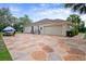 Spacious patterned driveway leading to a home, featuring ample parking at 12403 Moneta Rd, Weeki Wachee, FL 34614