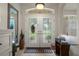 Bright foyer with tiled floor, patterned glass double doors, and transom window at 12403 Moneta Rd, Weeki Wachee, FL 34614
