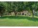 Attractive home surrounded by mature trees and a well-kept lawn at 12403 Moneta Rd, Weeki Wachee, FL 34614