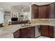 Well-appointed kitchen with stainless steel appliances, granite countertops, and a view to the adjacent living room at 12403 Moneta Rd, Weeki Wachee, FL 34614