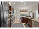 Open kitchen with a breakfast nook, featuring stainless steel appliances, and tiled floors at 12403 Moneta Rd, Weeki Wachee, FL 34614
