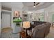 Spacious living room featuring tray ceilings, built-in shelving, and a comfortable leather sectional sofa at 12403 Moneta Rd, Weeki Wachee, FL 34614