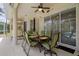Relaxing patio area featuring a dining table, seating, and views of the well-manicured backyard and pool area at 12403 Moneta Rd, Weeki Wachee, FL 34614