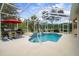 Backyard enclosed pool with a spa, outdoor seating area, and tropical landscaping for a private retreat at 12403 Moneta Rd, Weeki Wachee, FL 34614