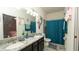 Bathroom with double vanity, modern lighting, and turquoise accents at 12458 Fish Cove Dr, Spring Hill, FL 34609