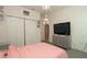 Well lit bedroom featuring a closet and gray tiled floor at 12458 Fish Cove Dr, Spring Hill, FL 34609