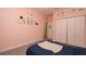 Charming bedroom featuring a closet, a picture ledge with decorations, and tile floors at 12458 Fish Cove Dr, Spring Hill, FL 34609