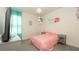 Well lit bedroom featuring a queen size bed and gray tiled floor at 12458 Fish Cove Dr, Spring Hill, FL 34609