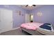 Bedroom featuring light purple walls, closet, and gray tiled floor at 12458 Fish Cove Dr, Spring Hill, FL 34609