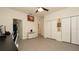 Spacious bedroom with gray tile flooring, ceiling fan, and ample storage at 12458 Fish Cove Dr, Spring Hill, FL 34609