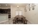 Elegant dining area with a rustic wooden table, benches, and access to the kitchen at 12458 Fish Cove Dr, Spring Hill, FL 34609