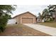 Charming single-story home with attached two car garage and spacious front lawn at 12458 Fish Cove Dr, Spring Hill, FL 34609