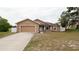 Charming single-story home with a well-maintained lawn, two-car garage, and neutral color palette at 12458 Fish Cove Dr, Spring Hill, FL 34609