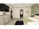Spacious main bedroom featuring wood-look dresser, en-suite bathroom and large format floor tile at 12458 Fish Cove Dr, Spring Hill, FL 34609
