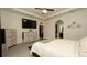 A spacious main bedroom featuring wood-look dresser, en-suite bathroom and large format floor tile at 12458 Fish Cove Dr, Spring Hill, FL 34609