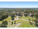 Aerial perspective of the community with lush golf course, community buildings, and surrounding landscape at 12920 Wedgewood Way # B, Hudson, FL 34667
