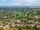 Sprawling aerial view of the condo community adjacent to the golf course, with verdant landscaping at 12920 Wedgewood Way # B, Hudson, FL 34667