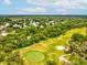Scenic aerial view of the community golf course, surrounded by lush green trees at 12920 Wedgewood Way # B, Hudson, FL 34667