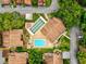 Aerial view of the community pool and shuffleboard courts, surrounded by lush greenery and well-kept residences at 12920 Wedgewood Way # B, Hudson, FL 34667