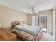 Bedroom featuring a ceiling fan and access to an outdoor patio at 12920 Wedgewood Way # B, Hudson, FL 34667