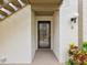 Exterior doorway featuring black trimmed storm door and neutral walls at 12920 Wedgewood Way # B, Hudson, FL 34667