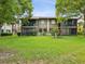 Building exterior showcasing screened lanais, multiple units, and a well-manicured lawn at 12920 Wedgewood Way # B, Hudson, FL 34667