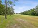 Scenic golf course with lush green grass, trees, and a clear blue sky at 12920 Wedgewood Way # B, Hudson, FL 34667