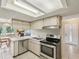 Functional kitchen with stainless steel appliances and a view into the dining area at 12920 Wedgewood Way # B, Hudson, FL 34667